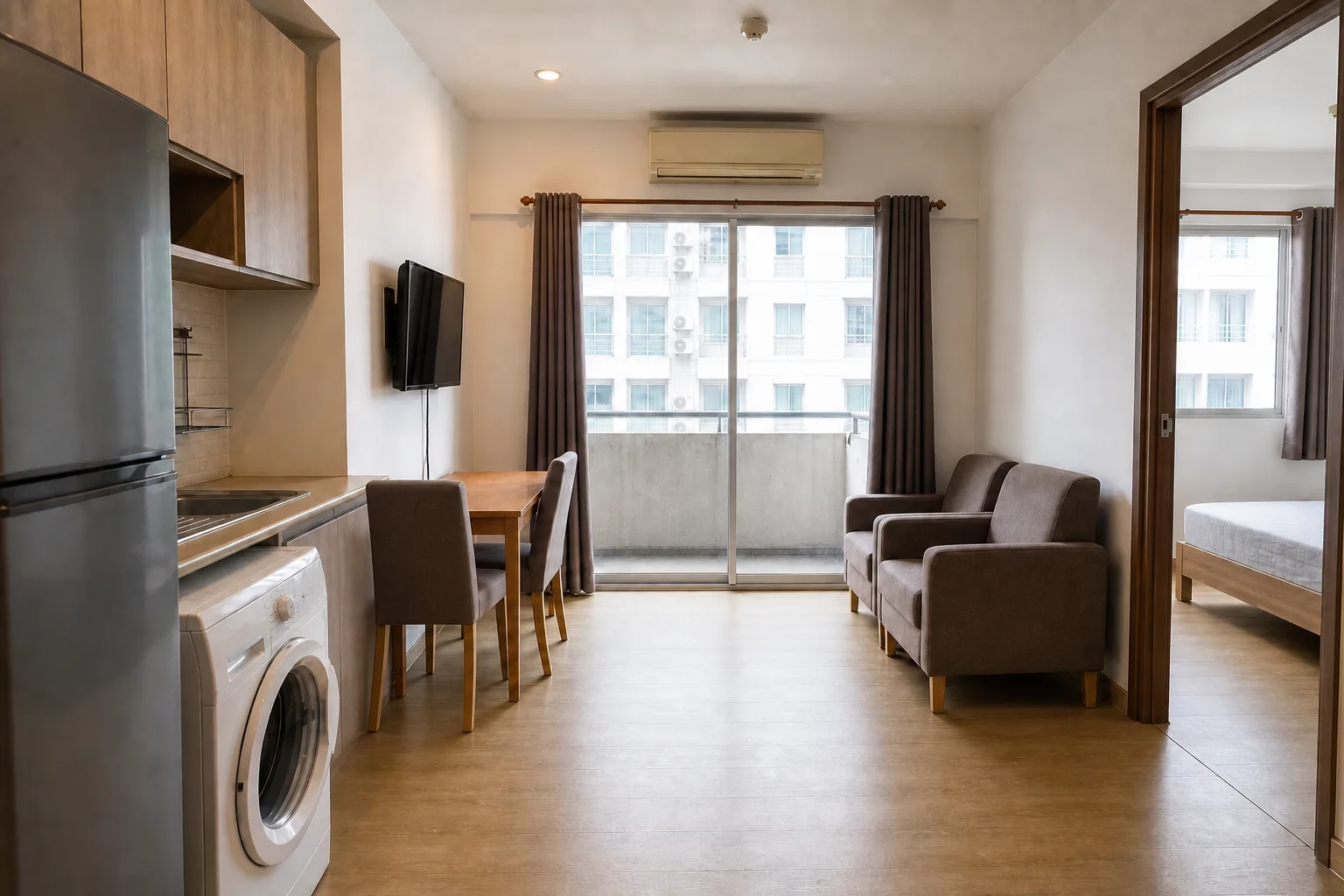 The one bedroom seen from the entry corner, with daylight from the window wall